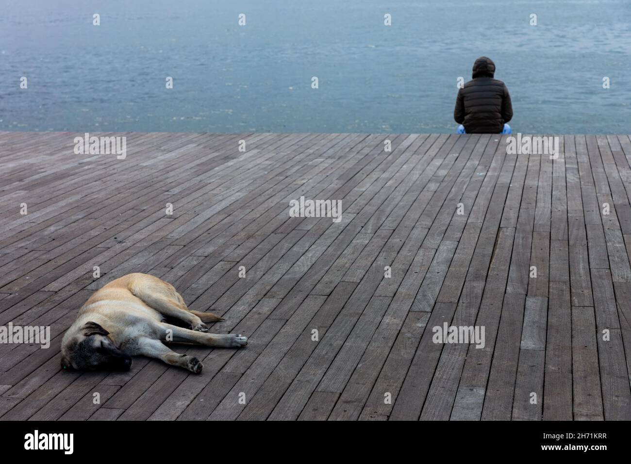 lonely man sitting by the sea in Istanbul Stock Photo