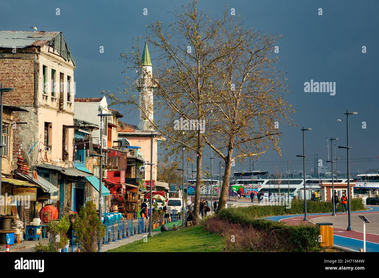 Old buildings and historical Makbul Ibrahim Pasha mosque with its wooden minaret at Karakoy coastline in Istanbul Stock Photo