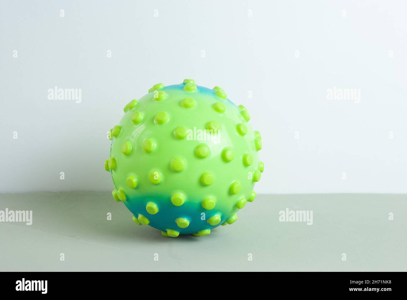 Childrens ball in the form of a virus on a gray background Stock Photo