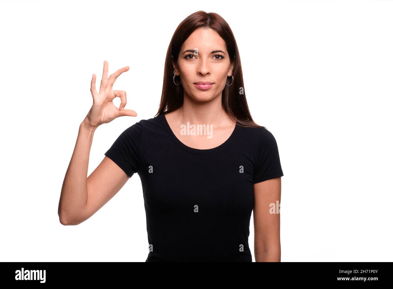 Isolated in white background brunette woman saying letter S in spanish ...