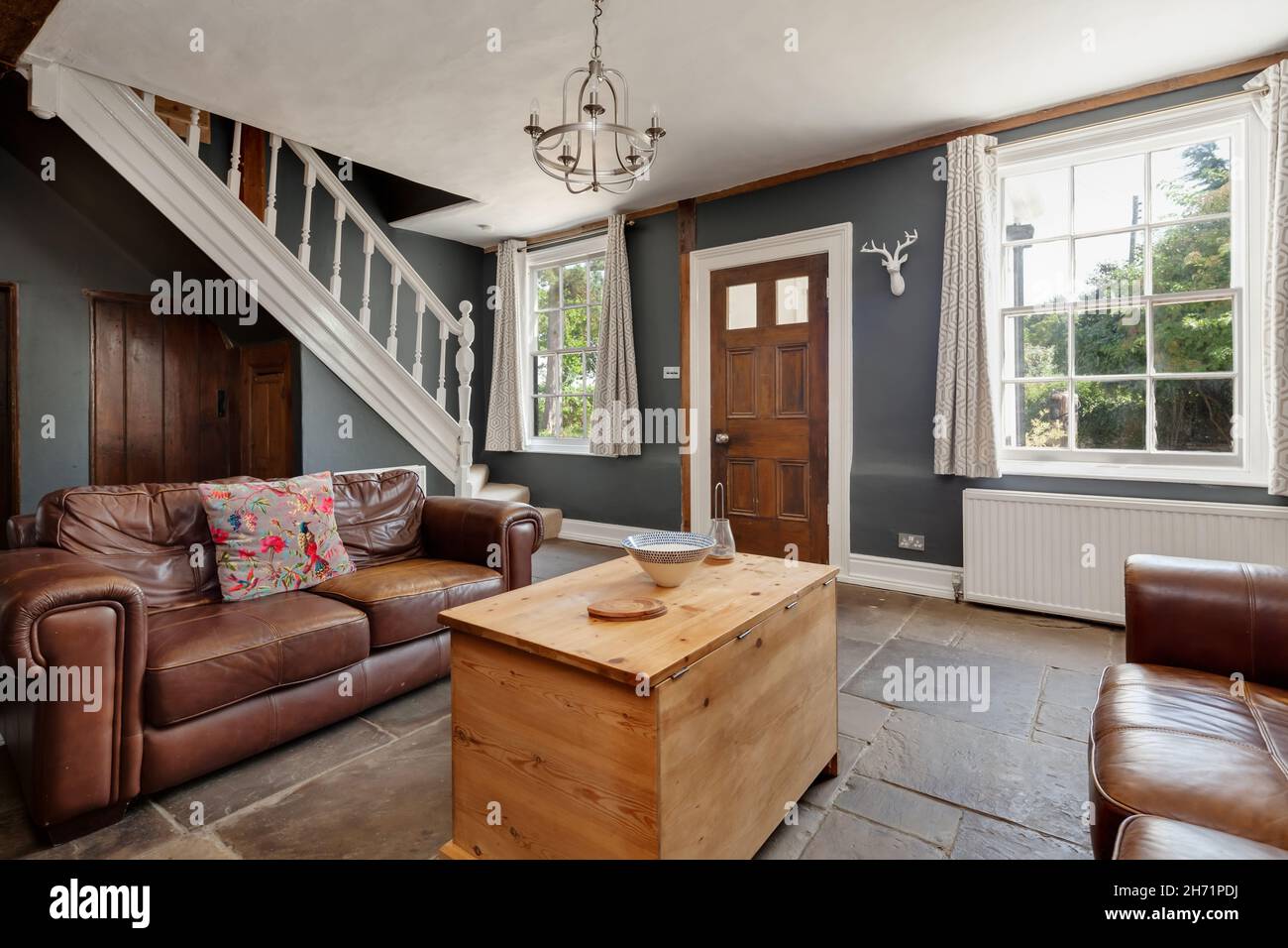 Ashdon, England  - July 25 2019: traditional farmhouse living room inside British home with flagstone floor Stock Photo
