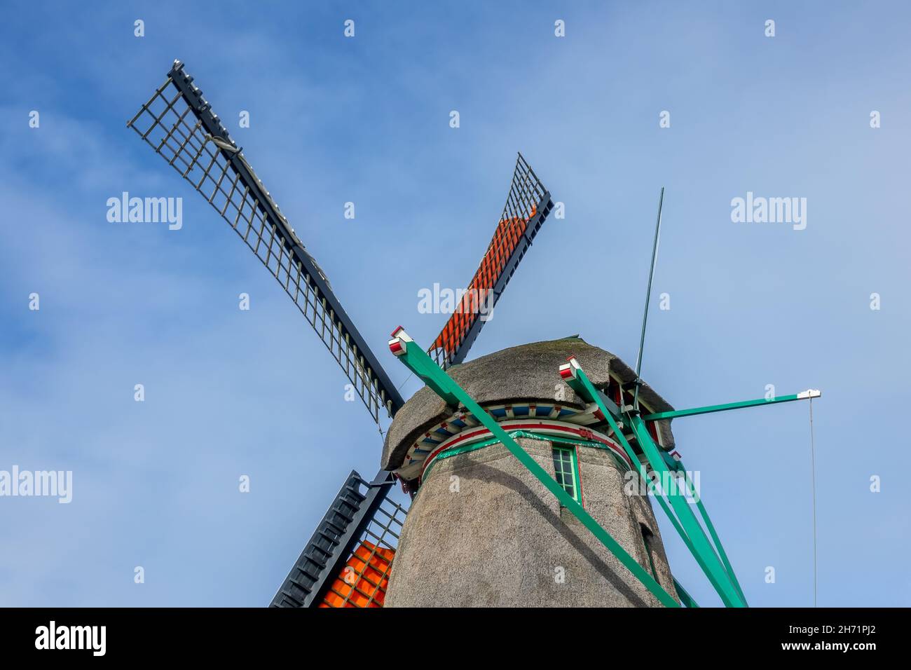 Netherlands. Authentic Dutch windmill against the blue sky. Roof and blades Stock Photo