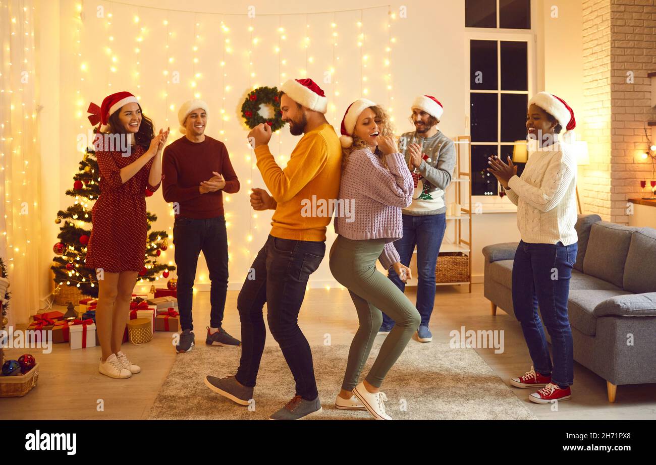Overjoyed friends dance celebrate winter holidays together Stock Photo