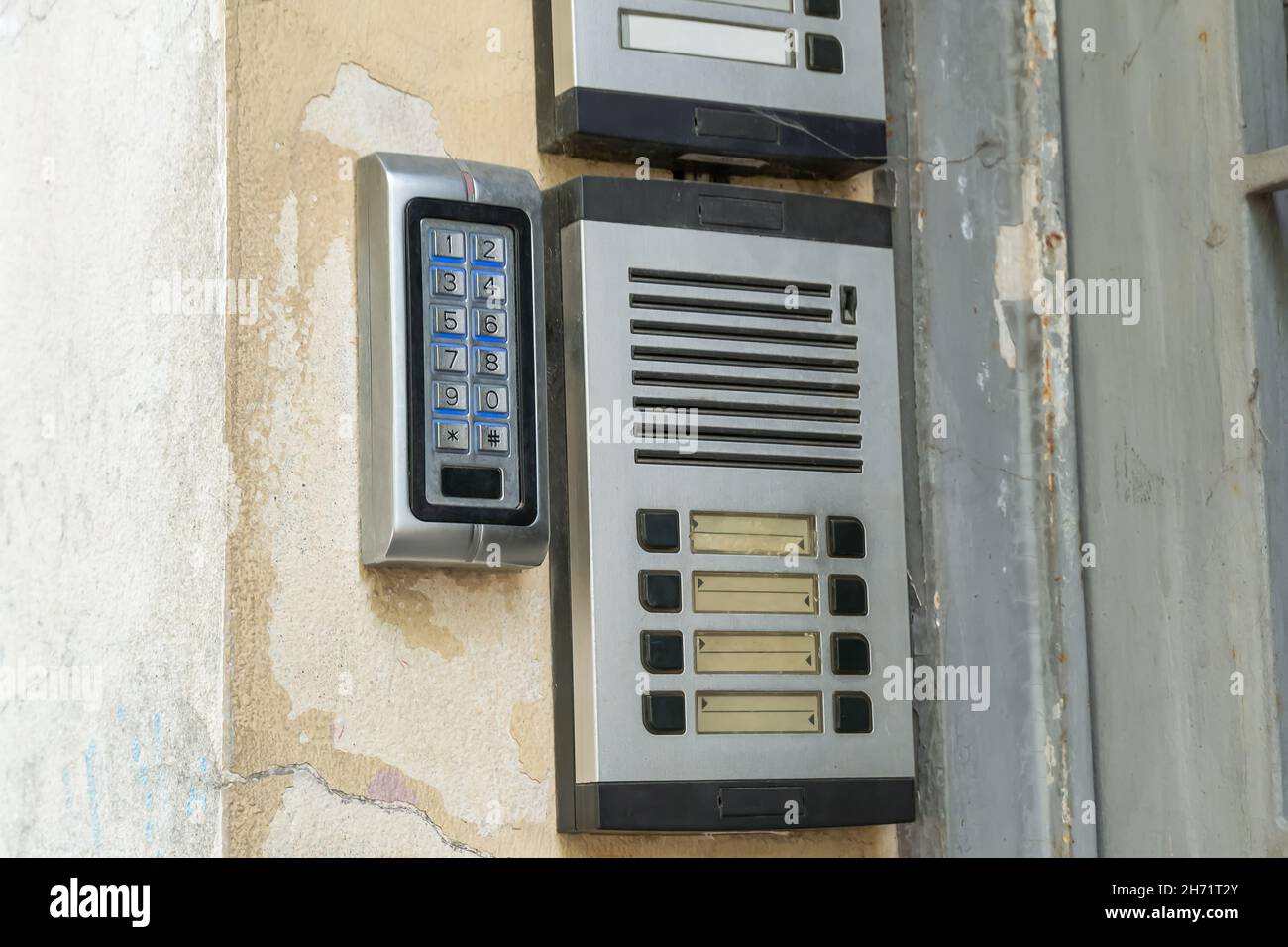 Old-fashioned vintage doorbells with blank nameplates. An outdoor intercom outside a residential building with empty name cards. Stock Photo