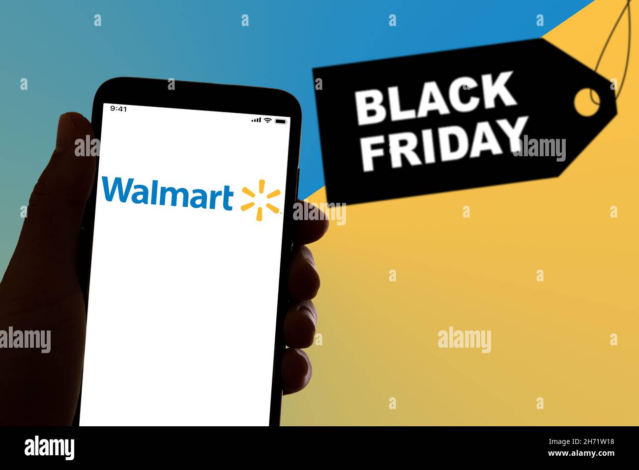 The Walmart shopping app logo is seen on the display of a smarthphone with a 'Black Friday' sign in the background in Barcelona, Spain on November 19, 2021. (Photo by Davide Bonaldo/Sipa USA) Stock Photo