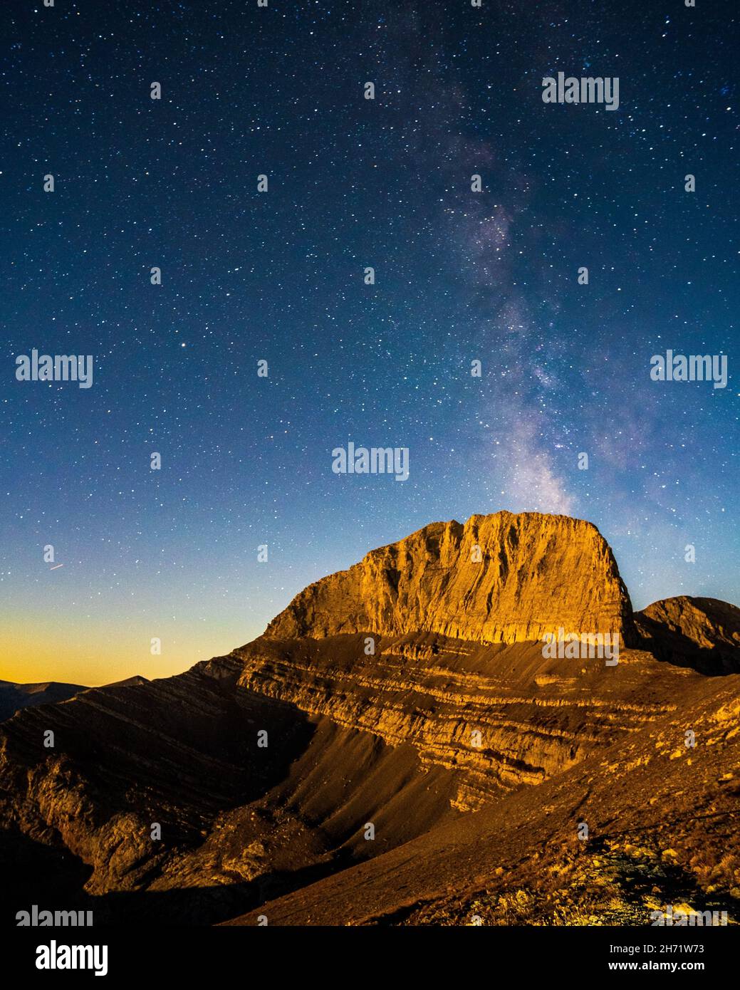 Vertical shot of Mount Olympus with the Milky Way galaxy in the starry background in Greece Stock Photo