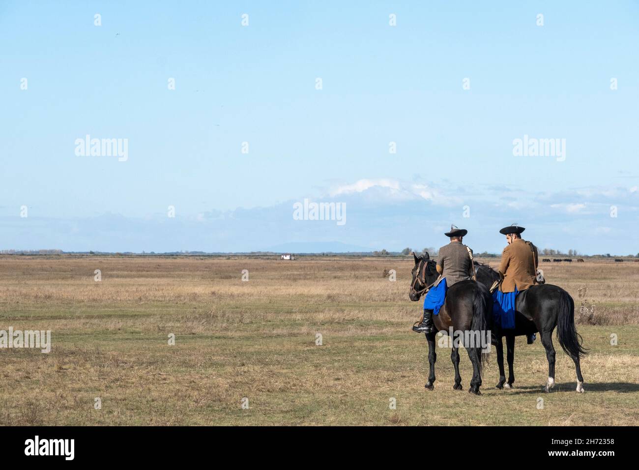 Two Hungarian Csikos riding  in the pusta, Hortobagy National Park, Hungary Stock Photo