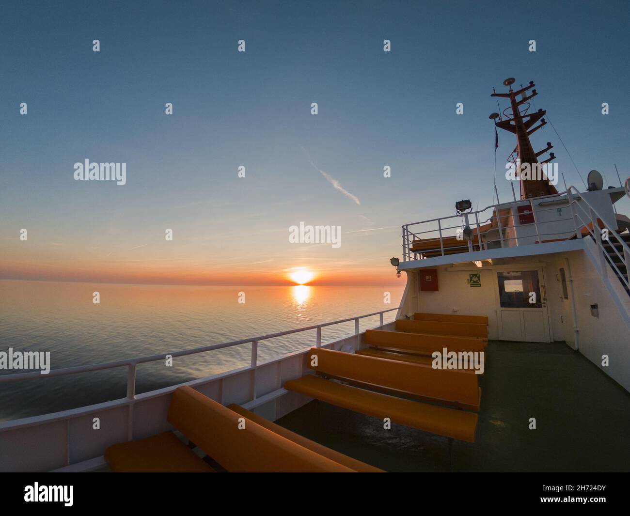Beautiful scene of a sunset in the sea and cloudy sky Stock Photo - Alamy