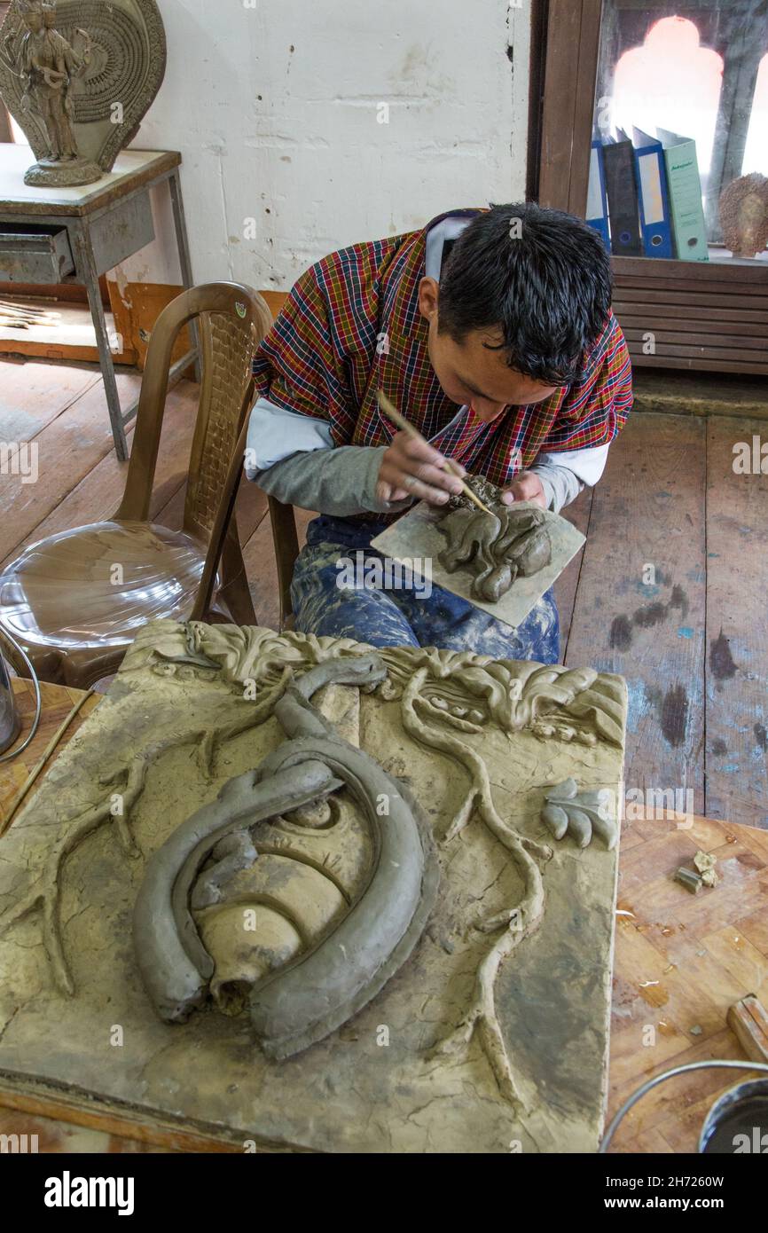 A Bhutanese art student works on a ceramic project in the National Institute for the Thirteen Arts in Thimphu, Bhutan. Stock Photo