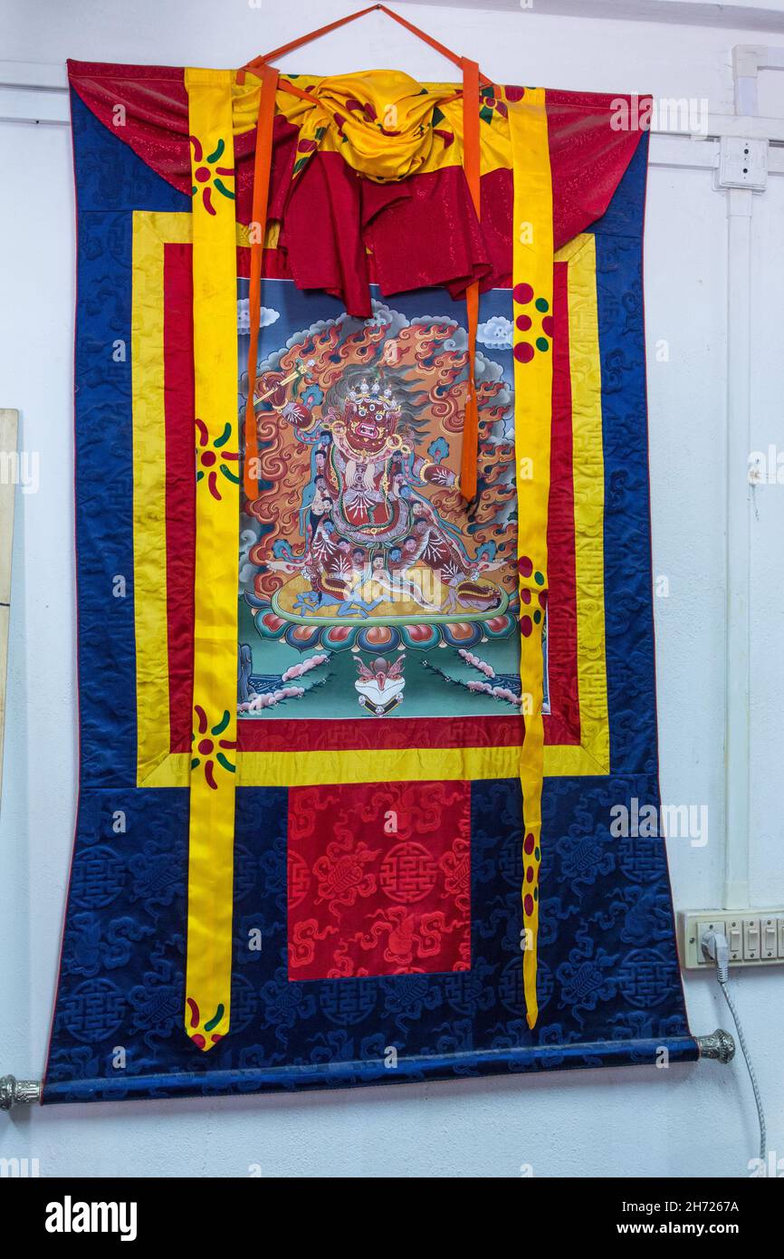 A silk wall hanging of a Buddhist wrathful deity in the National Institute of the Thirteen Arts in Thimphu, Bhutan. Stock Photo