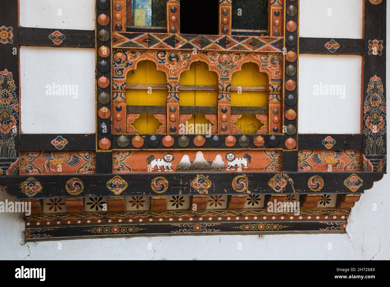 Detail of the Buddhist religious art painted on the window frame of a farm house near Paro, Bhutan. Stock Photo