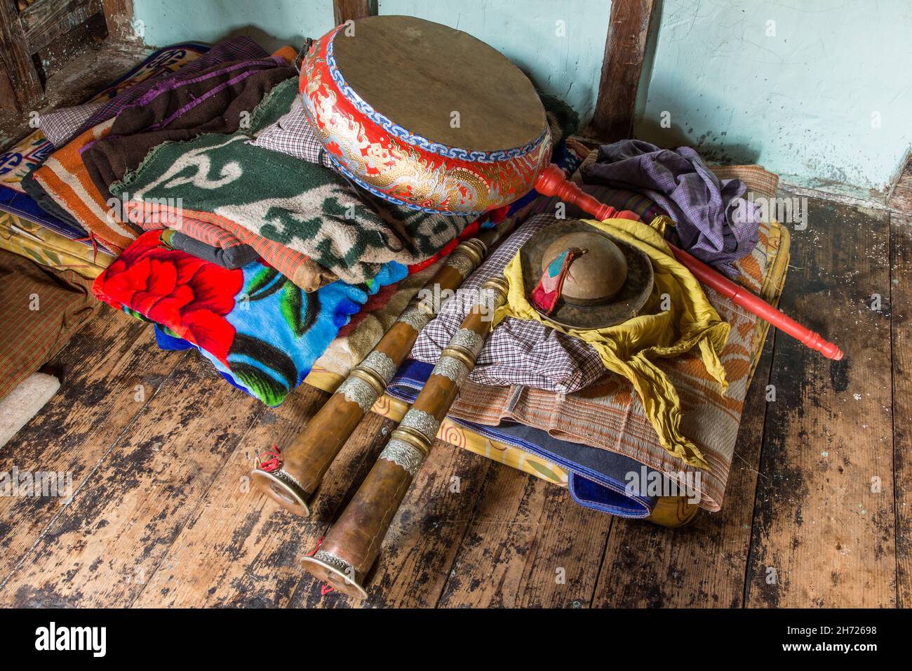 A Tibetan ceremonial Nga drum, dungchen horns and cymbals in a ...