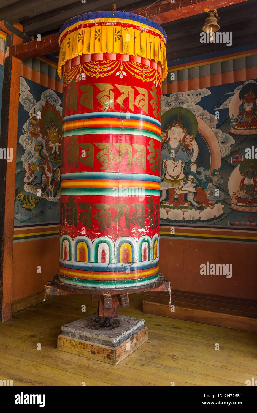 Buddhist religious art and a giant prayer wheel in the Dechen Phodrang Monastery in Thimphu, Bhutan. Stock Photo
