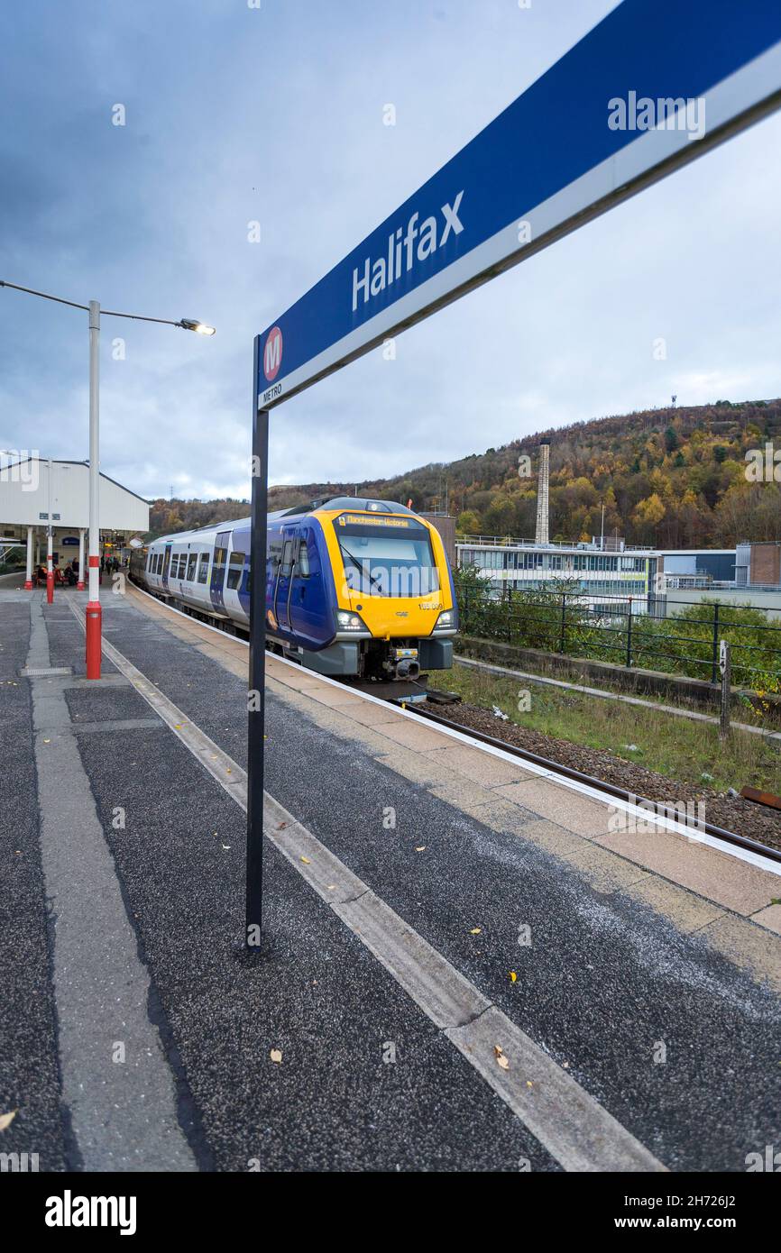 Northern Rail trains pass through the West Yorkshire railway station of Halifax, Calderdale, England, UK Stock Photo