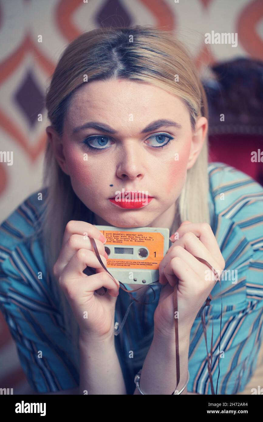 Girl with 80s tape cassette Stock Photo