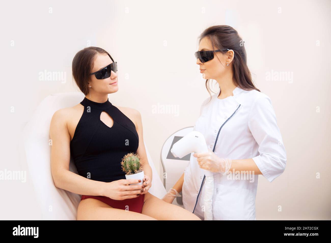 Concept bikini zone laser epilation, woman holding cactus on hand with