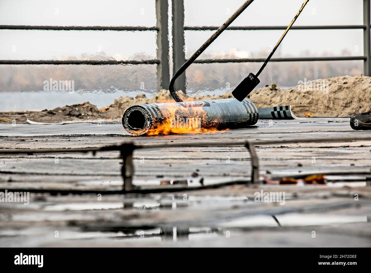 The process of installing roofing material using a blowtorch. The