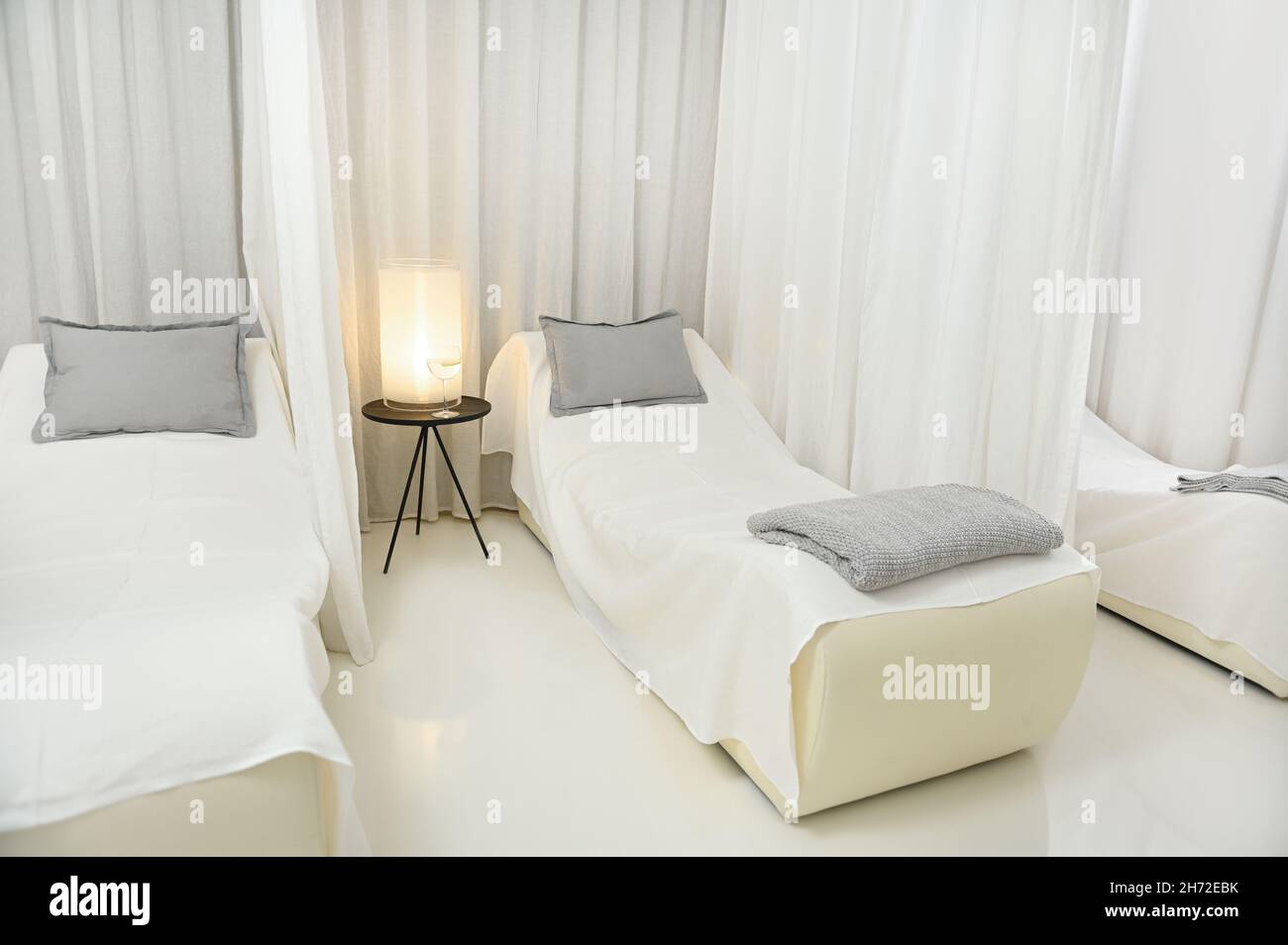 Advertisement shot of a beautiful luxurious white interior of a massage room with two beds for two people to relax and in a modern wellness spa. Copy Stock Photo