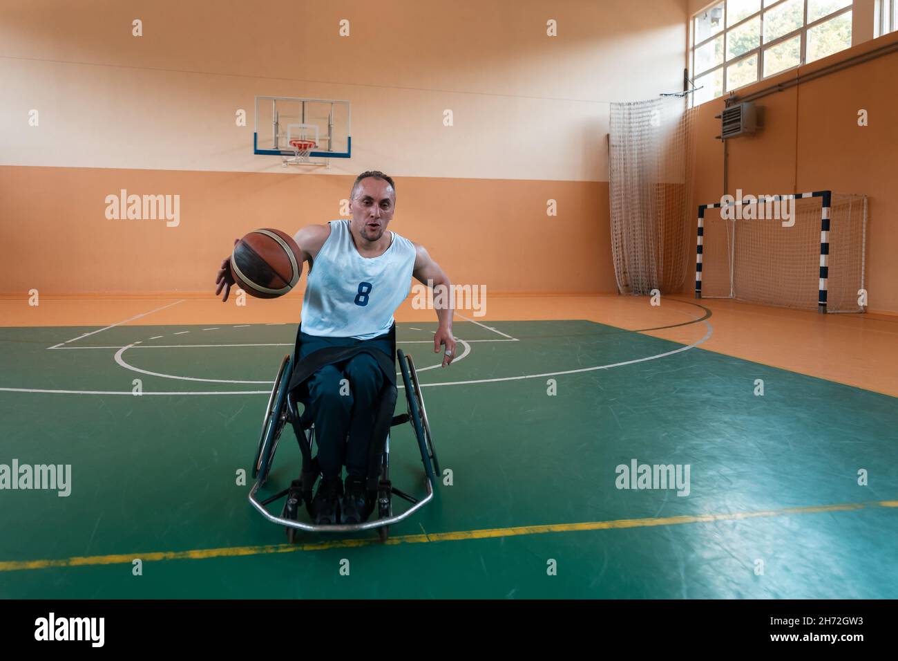 a photo of a war veteran playing basketball in a modern sports arena