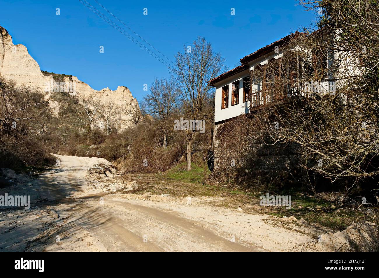 Old traditional houses against the backdrop of the famous sand pyramids in the town of Melnik, Bulgaria Stock Photo