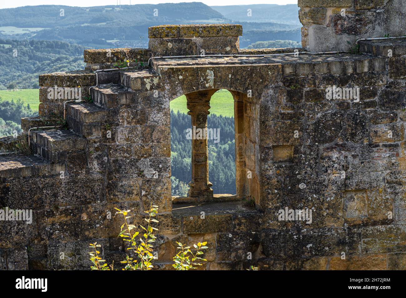 Windows inside of the massive high walls of an old medieval castle Stock Photo