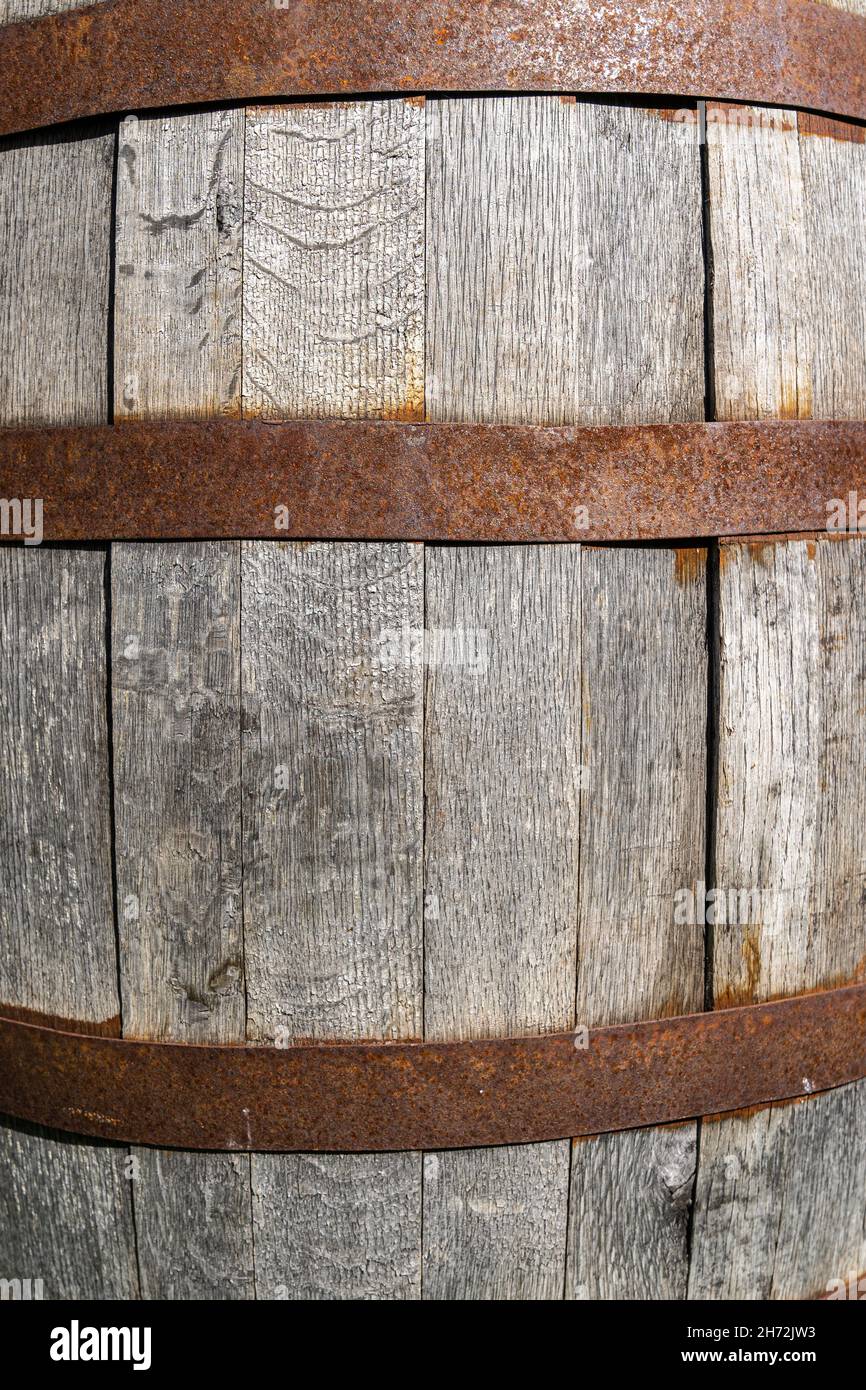 Big wooden wine cask with rusted barrel hoops Stock Photo