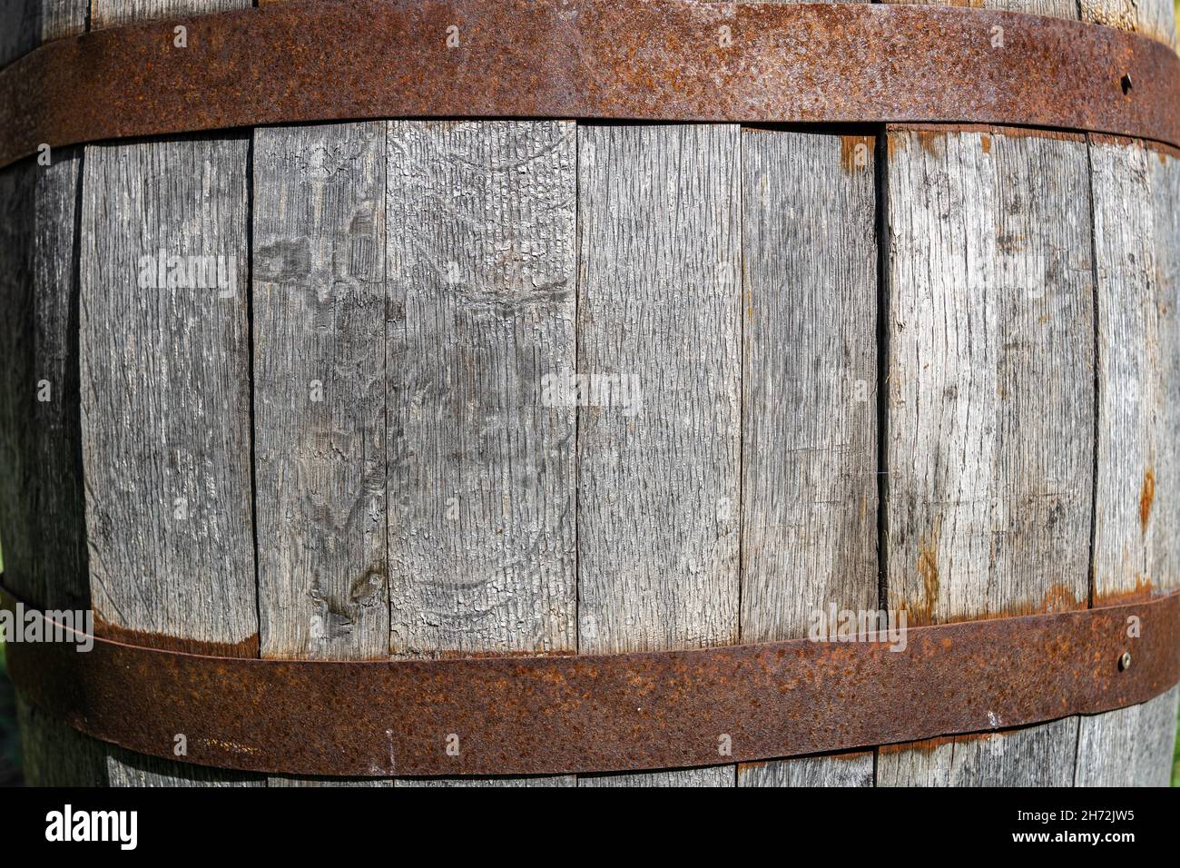 Big wooden wine cask with rusted barrel hoops Stock Photo
