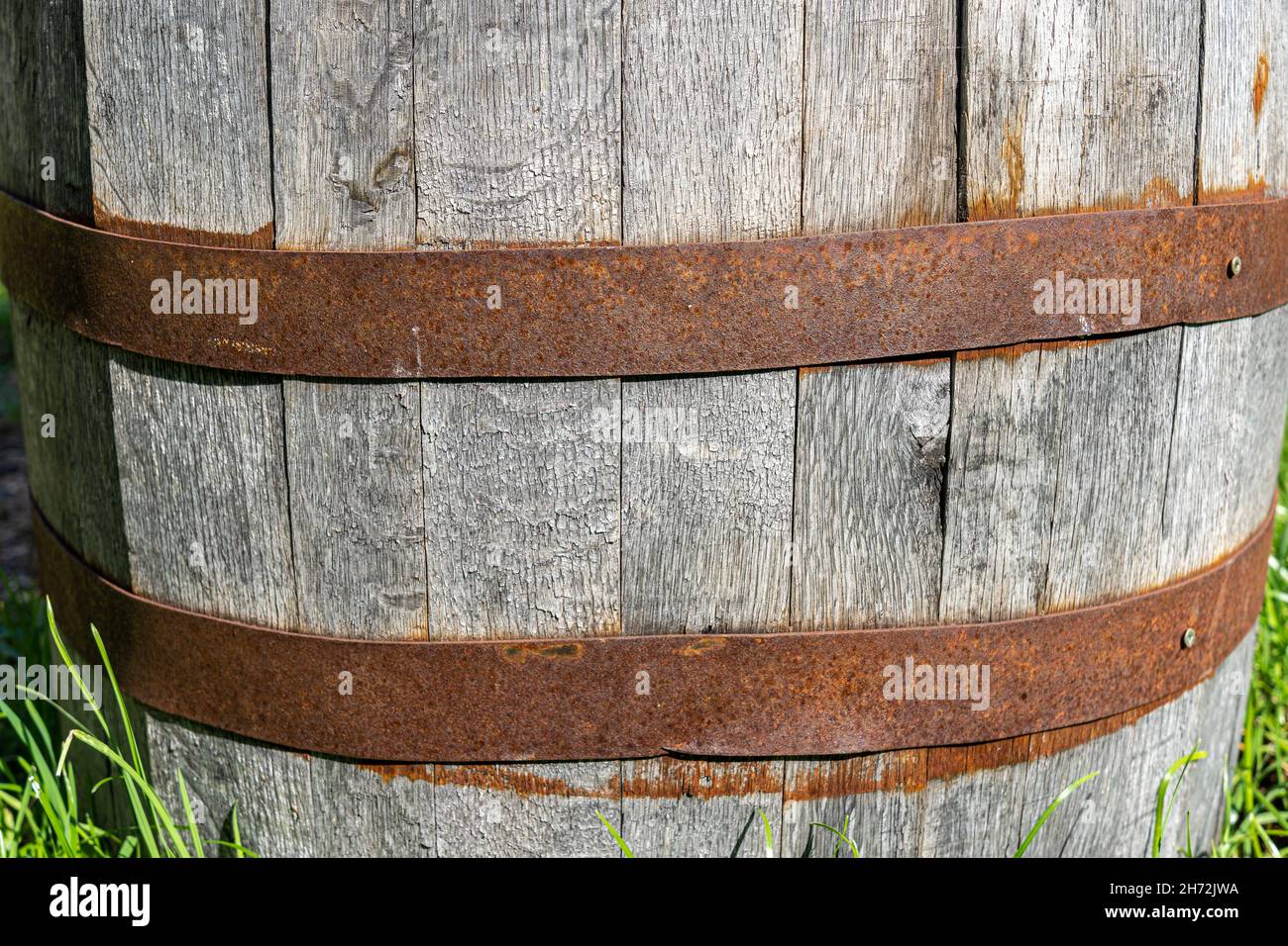 Big wooden wine cask with rusted barrel hoops Stock Photo