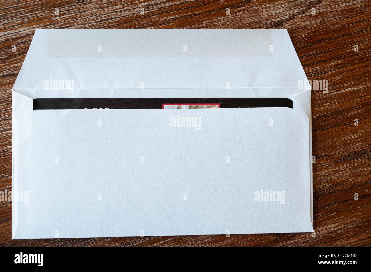 blank envelope ready to be sealed and sent in the mail. Dark colored