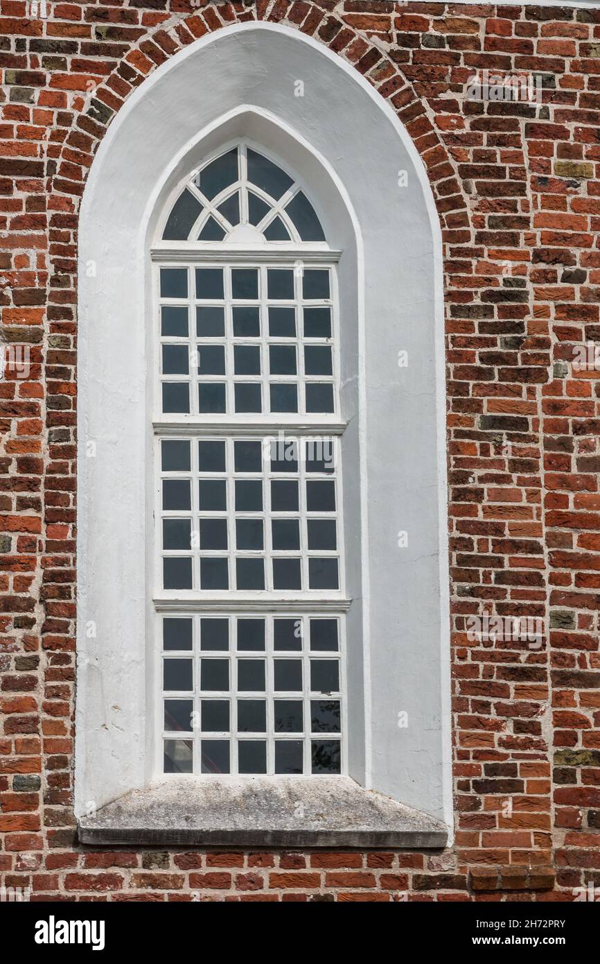 Window of a church with walls of bricks Stock Photo