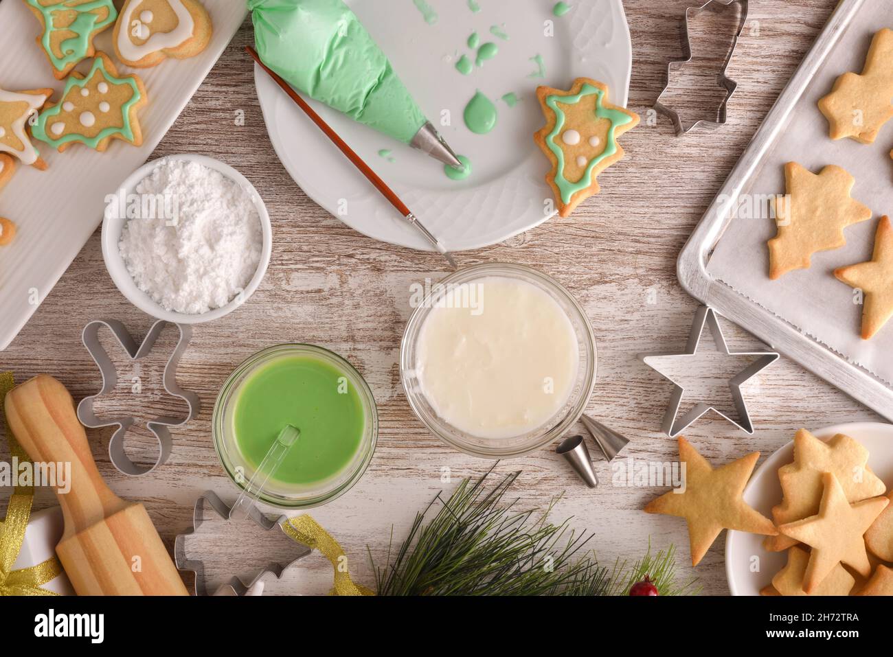 Detail decorating Christmas themed cookies with colored icing top Stock Photo