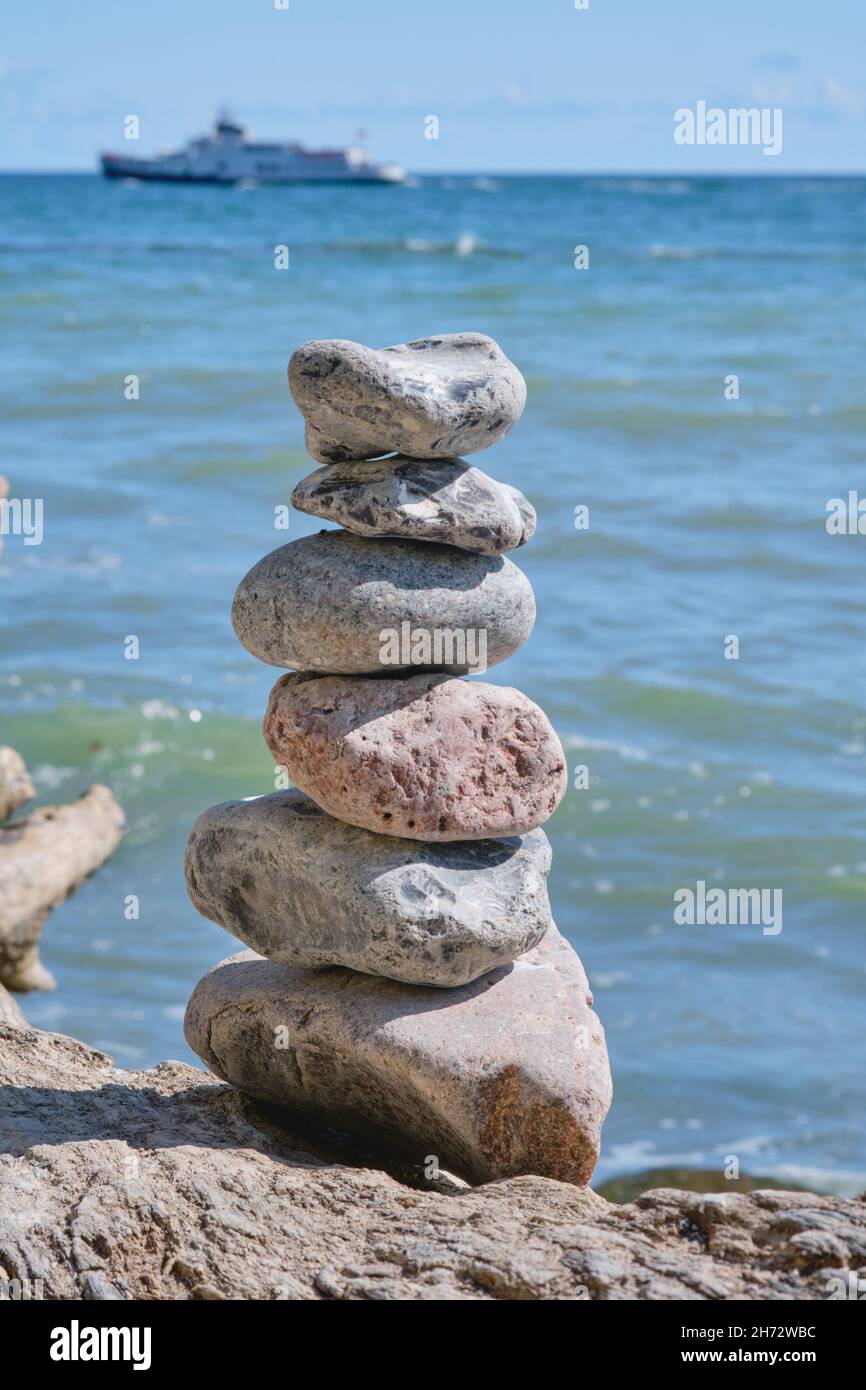 View of stone tower on the beach and sea as background Stock Photo - Alamy