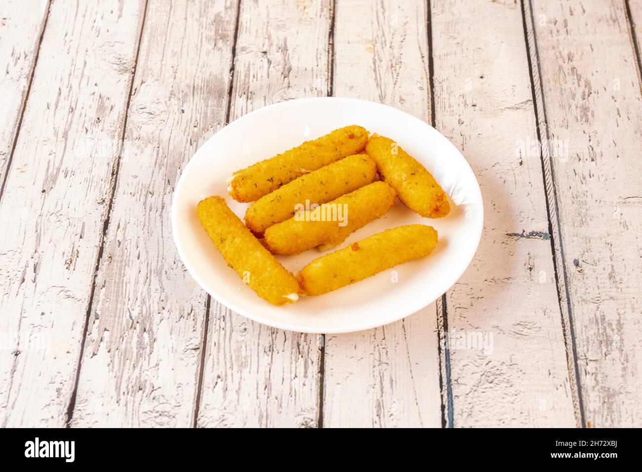 Mozzarella sticks are long pieces of mozzarella cheese that are battered or breaded and fried. Often served in restaurants as an aperitif Stock Photo