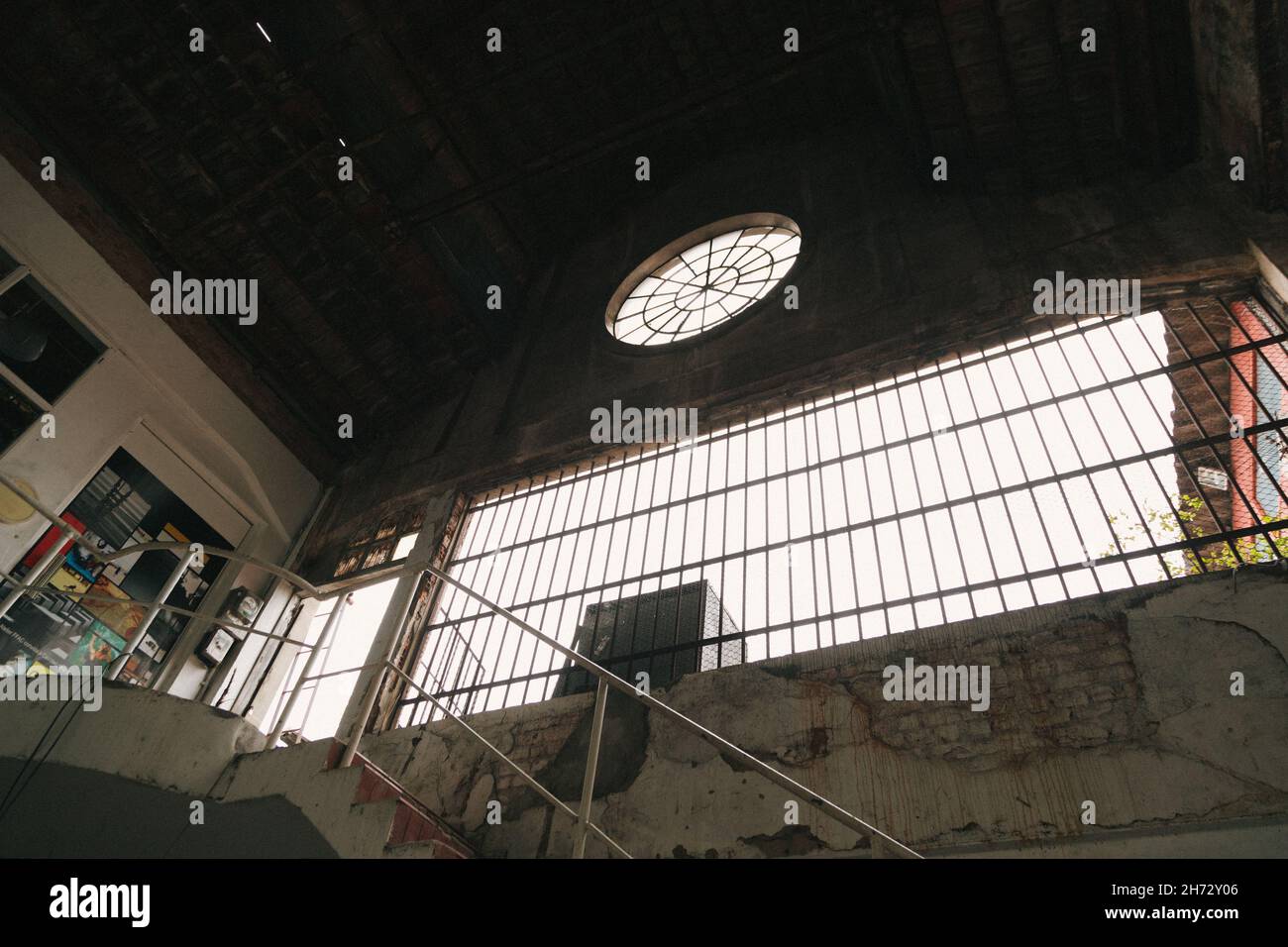 Low angle shot of an old weathered building wall with large windows ...