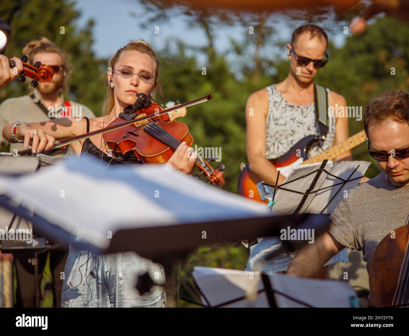 Beautiful woman violinist playing violin in orchestra Stock Photo - Alamy