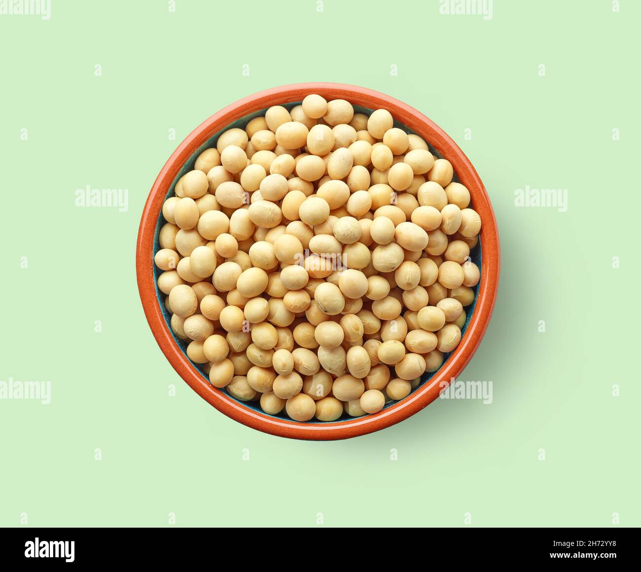 bowl of soy beans on light green background, top view Stock Photo