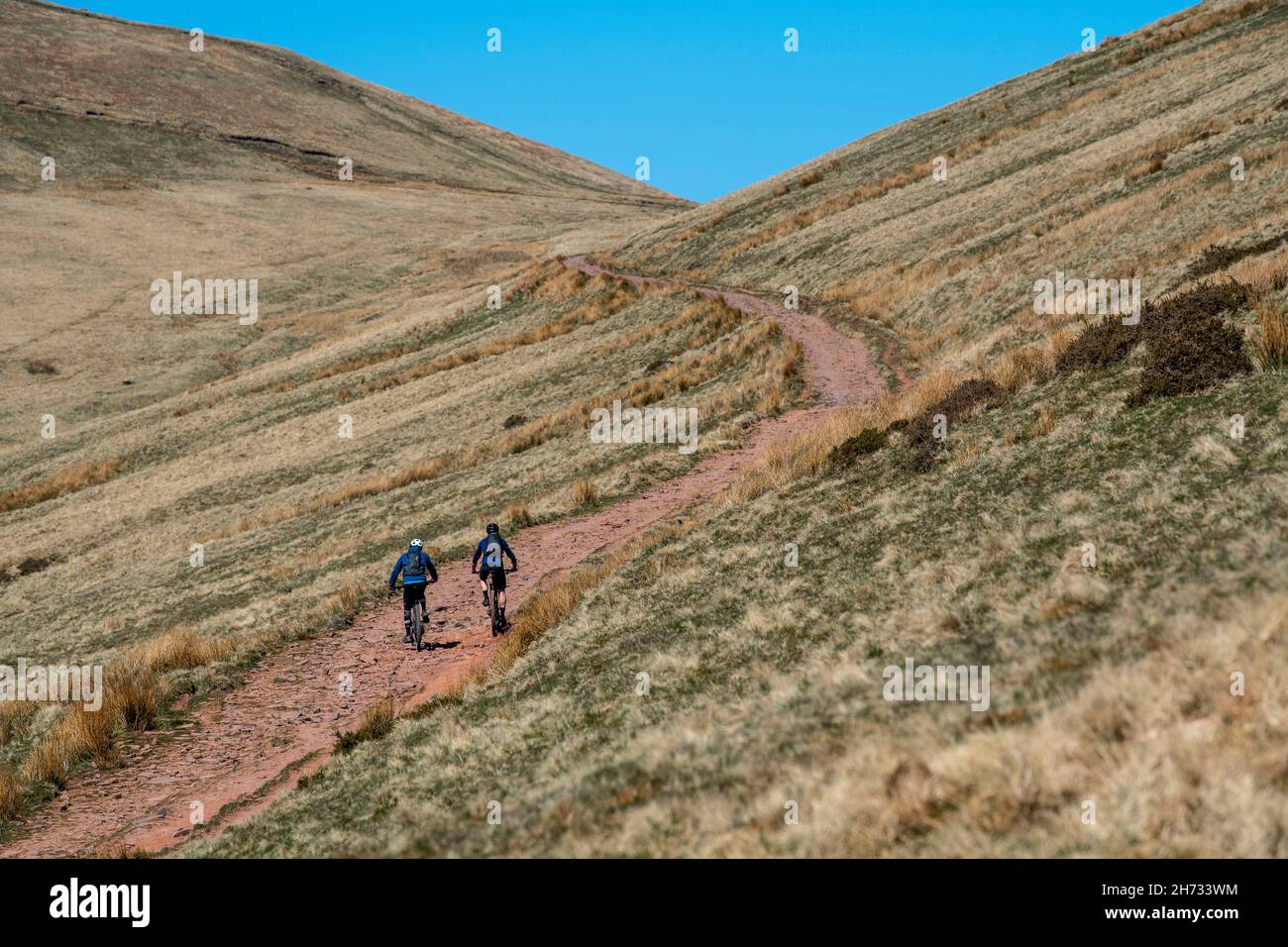 Two men ride mountain bikes in the Brecon Beacons national Park in