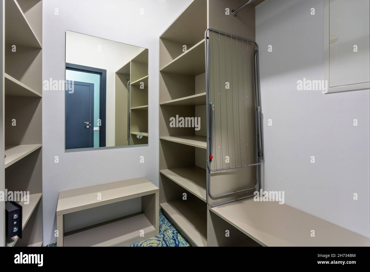 Dressing room with shelves and a mirror Stock Photo Alamy
