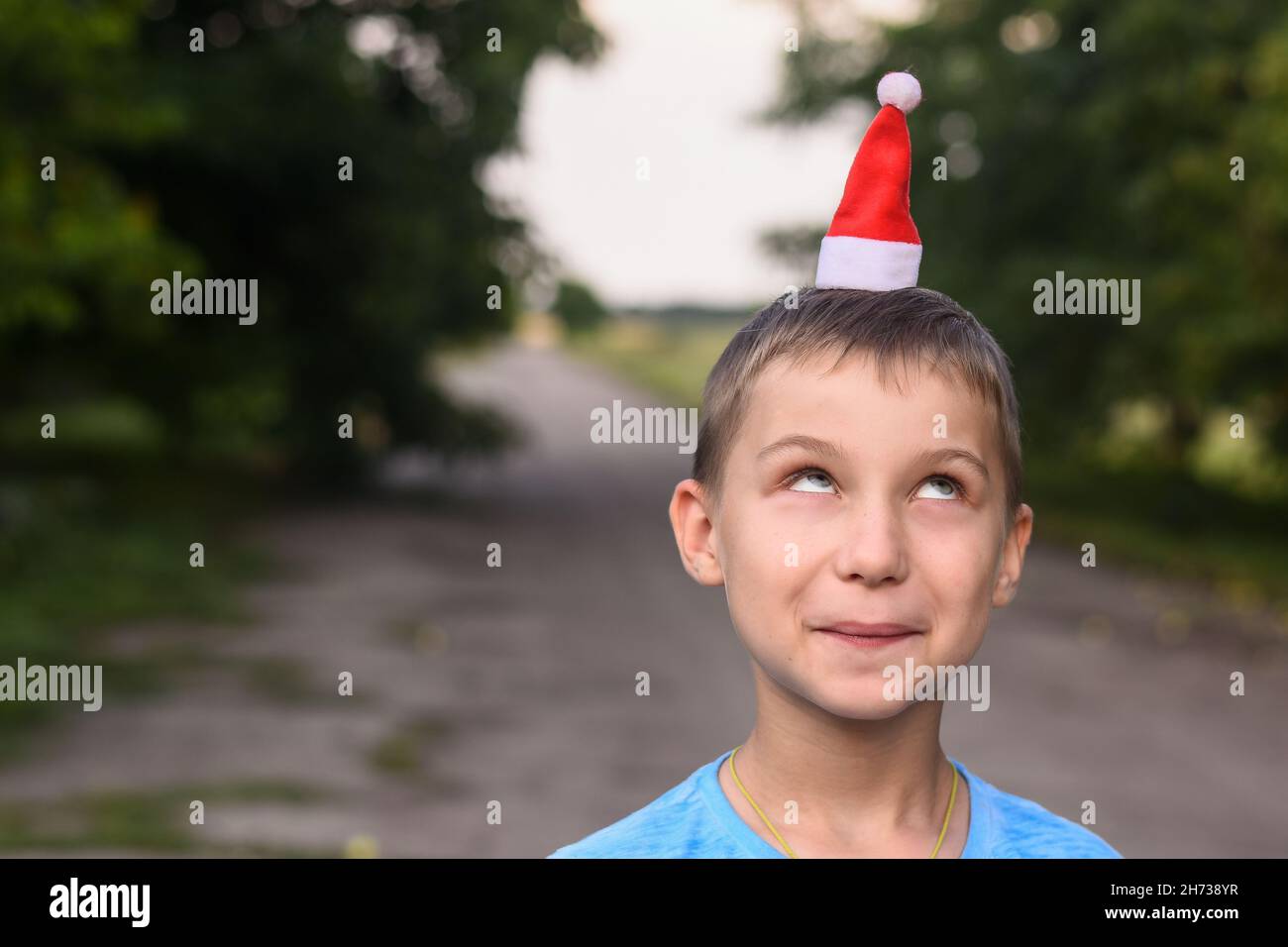 funny boy put a little Santa hat on his head. mock up Stock Photo