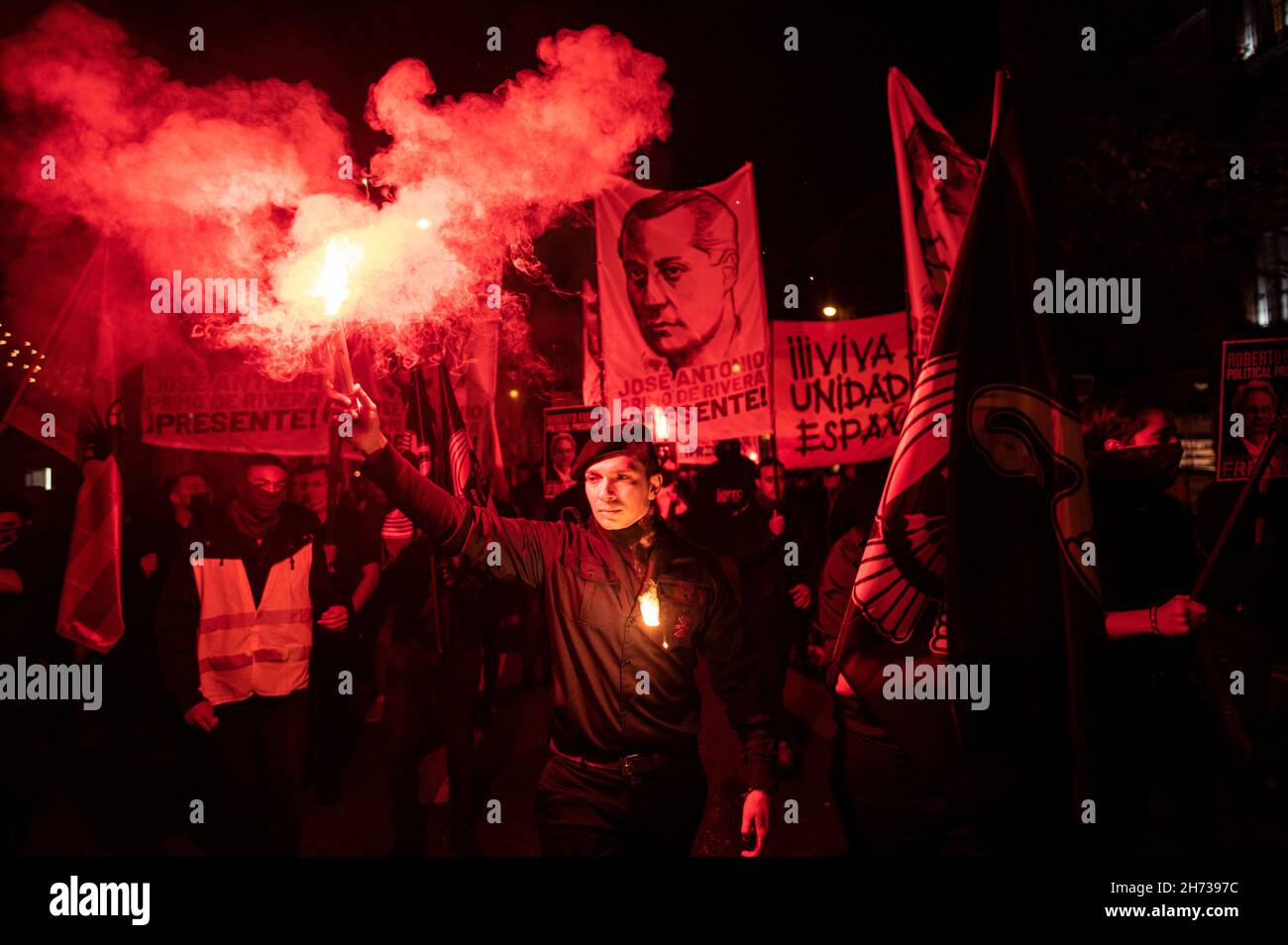 Madrid, Spain. 19th Nov, 2021. Far right wing members and supporters of La Falange carrying banners and flares during a demonstration for the anniversary of the death of Jose Antonio Primo de Rivera, founder of La Falange, commemorating the 85th anniversary of his death on 20 November 1936, shot at the beginning of the Spanish Civil War. Credit: Marcos del Mazo/Alamy Live News Stock Photo