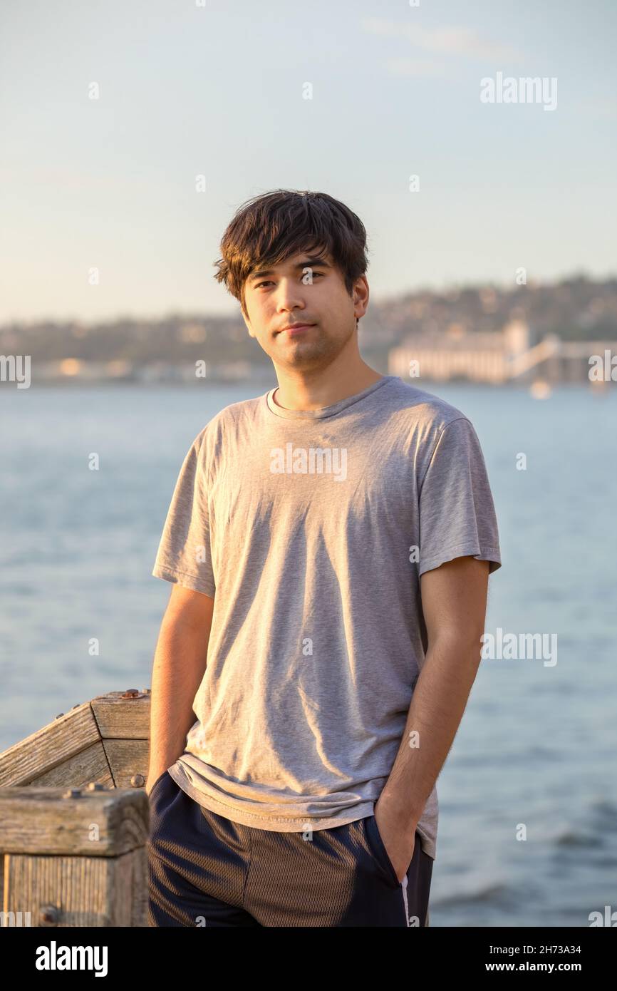 Handsome biracial Asian, Caucasian mixed race young man standing