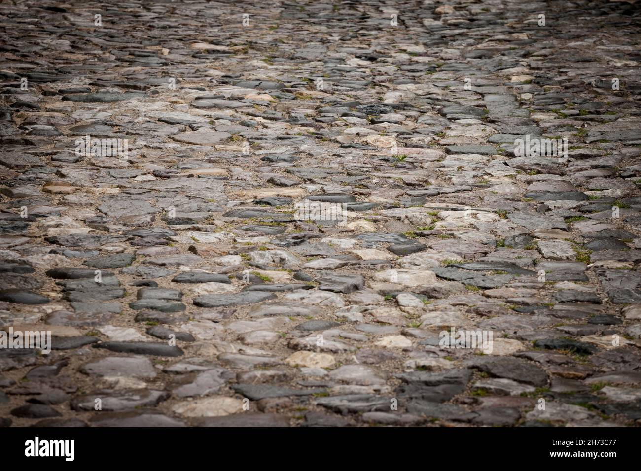 Picture of a road made of cobblestone, decaying, used as pavement Stock