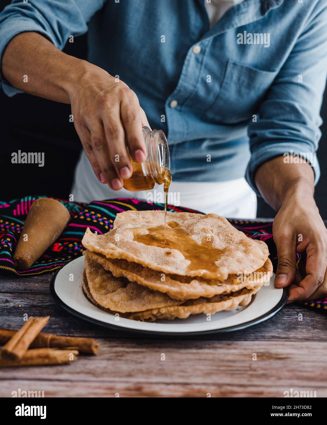 hands of mexican man cooking buñuelos, recipe and ingredients of traditional dessert for Christmas in Mexico Stock Photo