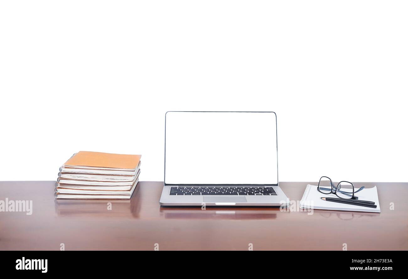 Laptop with notebooks and notes on the desktop isolated on white background Stock Photo