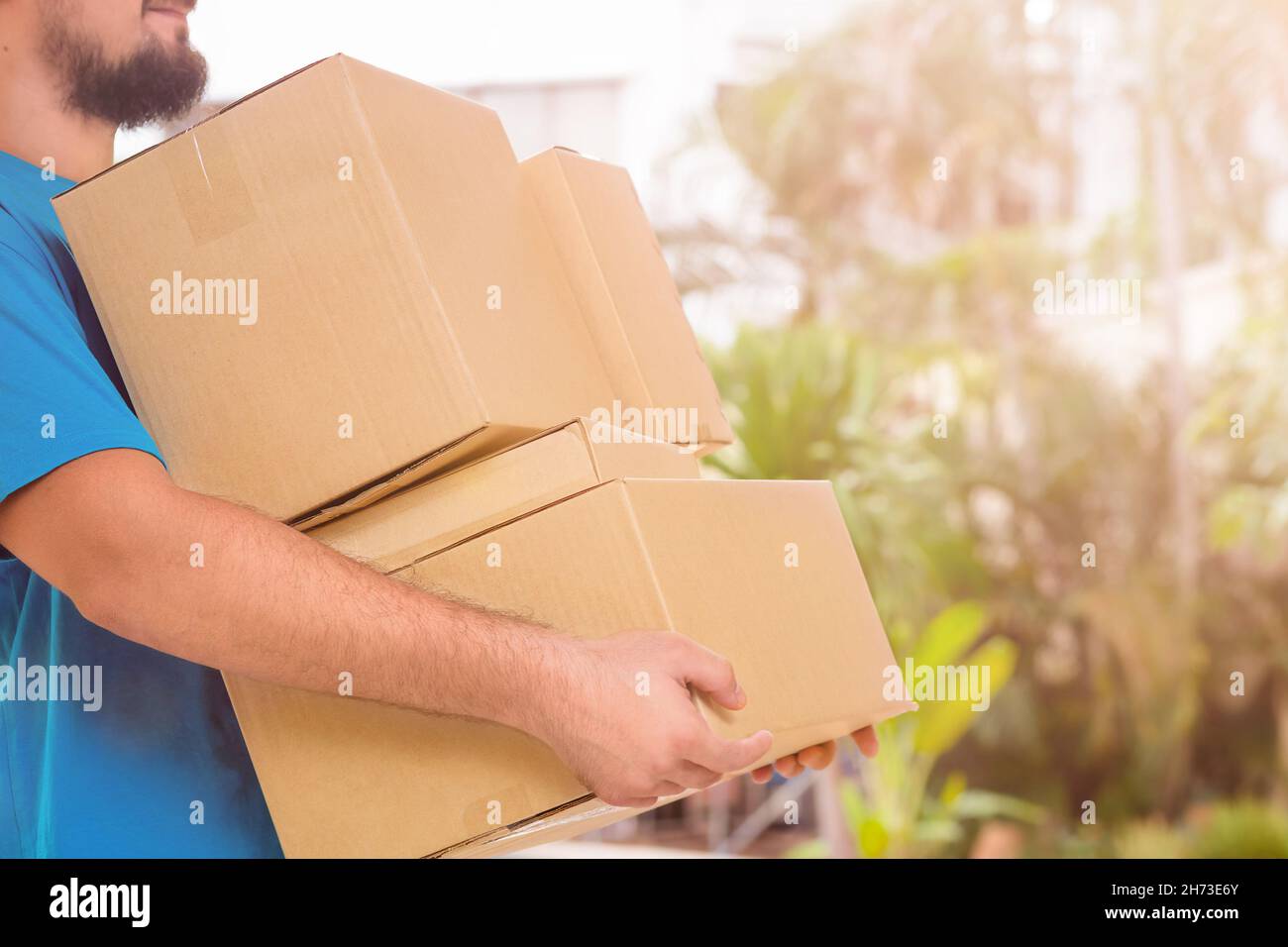 Happy man carries cardboard boxes delivery, moving Stock Photo Alamy