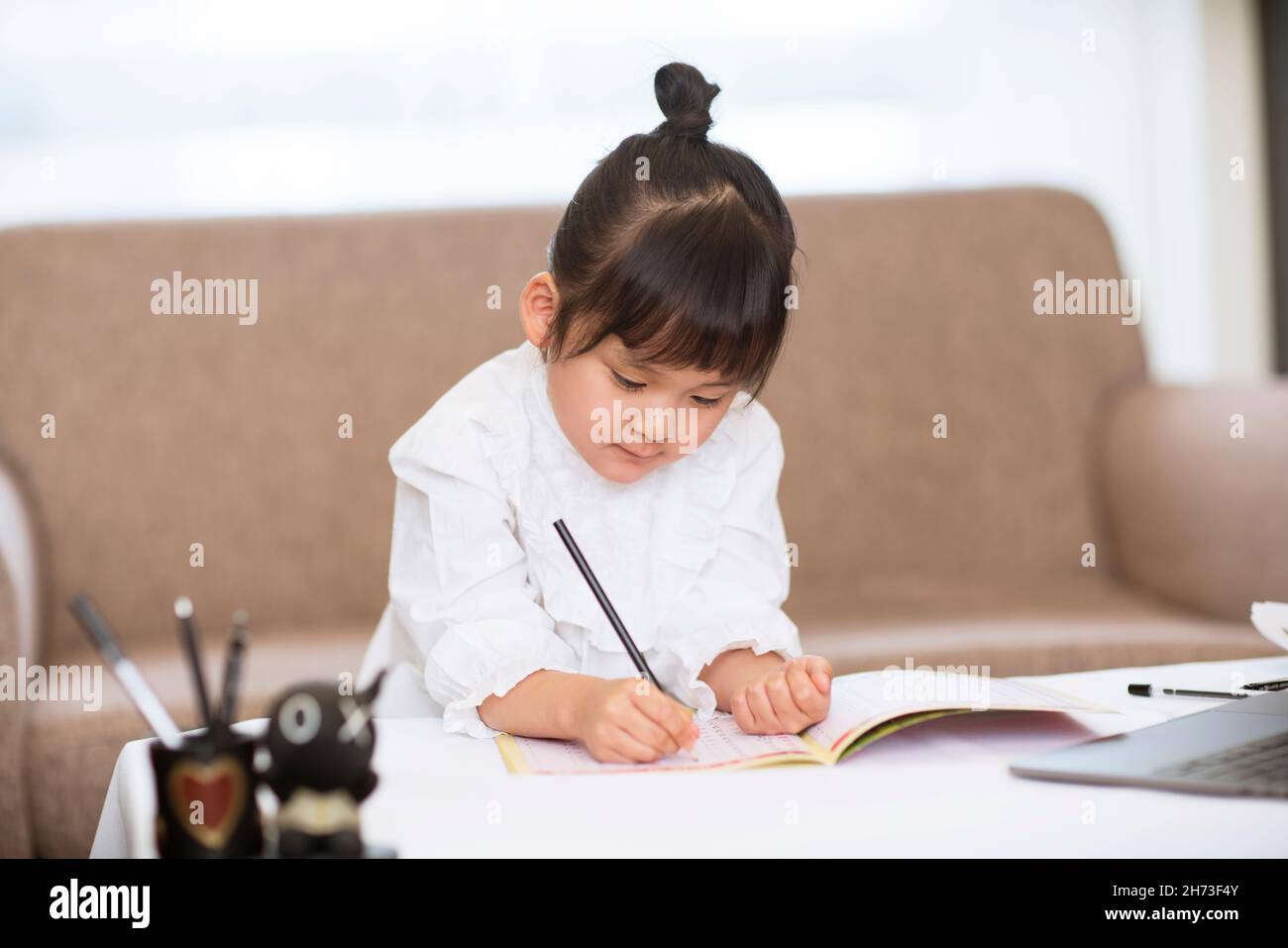 Little girl doing her homework Stock Photo