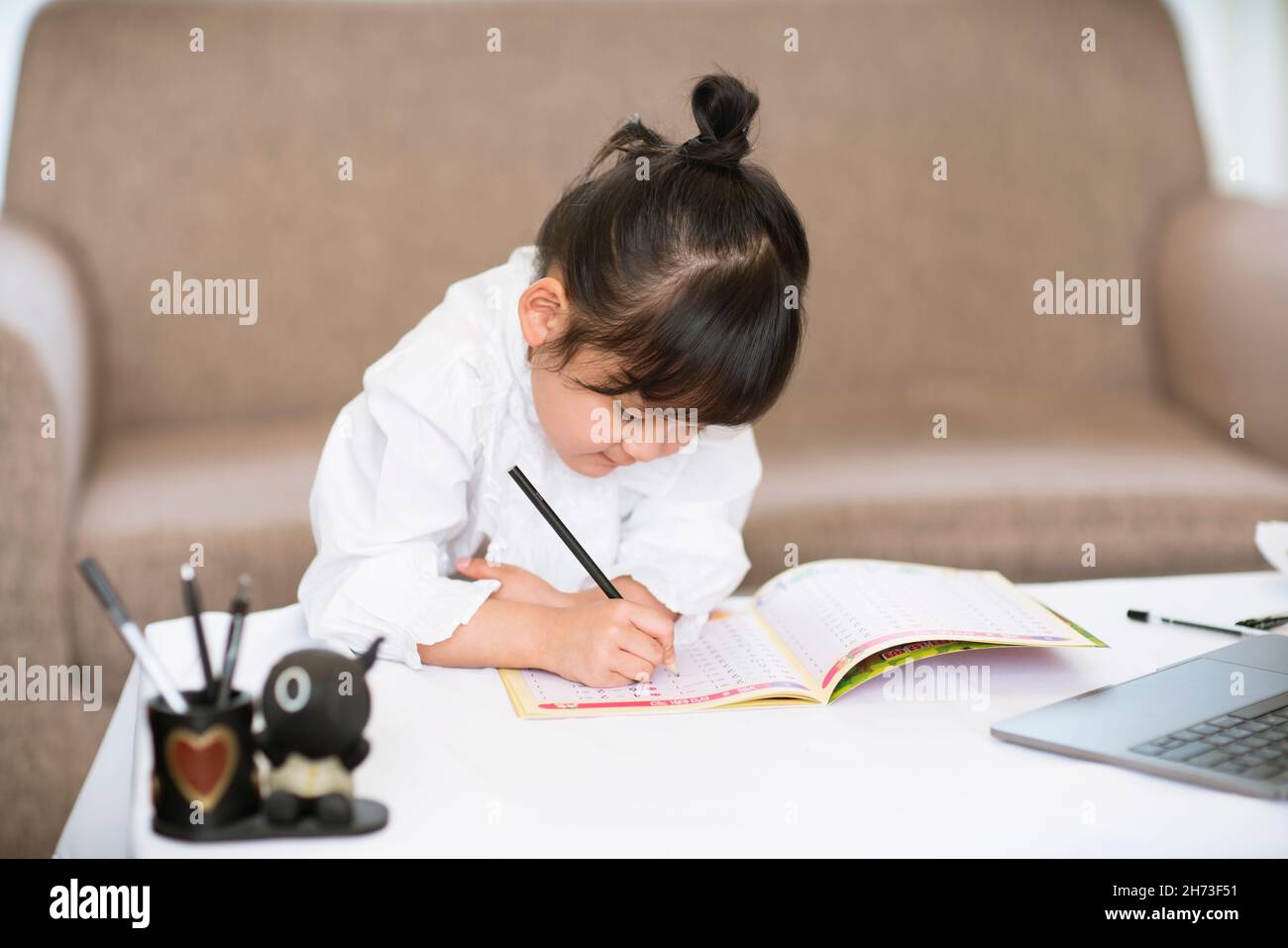 Little girl doing her homework Stock Photo