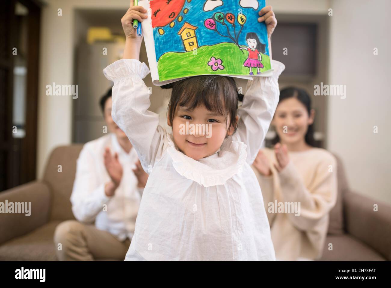 Happy little girl showing her painting Stock Photo