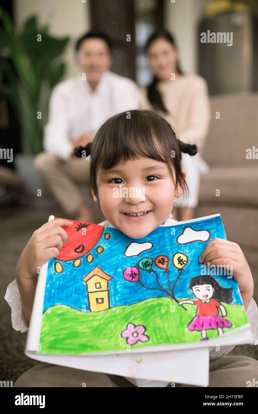 Happy little girl showing her painting Stock Photo