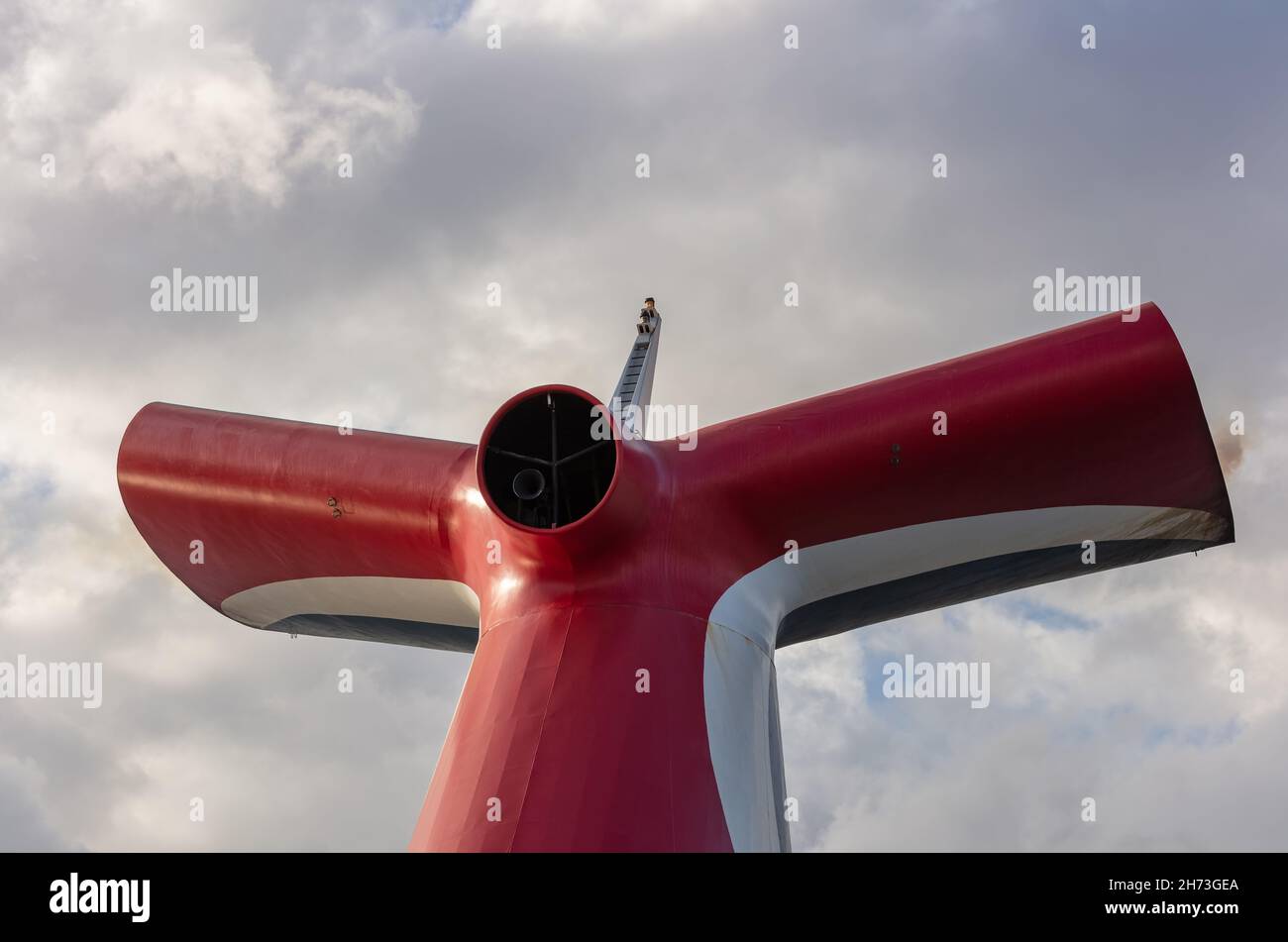 Saint Vincent - May 13, 2020: Low angle shot of red, white, and blue funnel on Carnival Freedom. Grey sky with white clouds in the background, Stock Photo